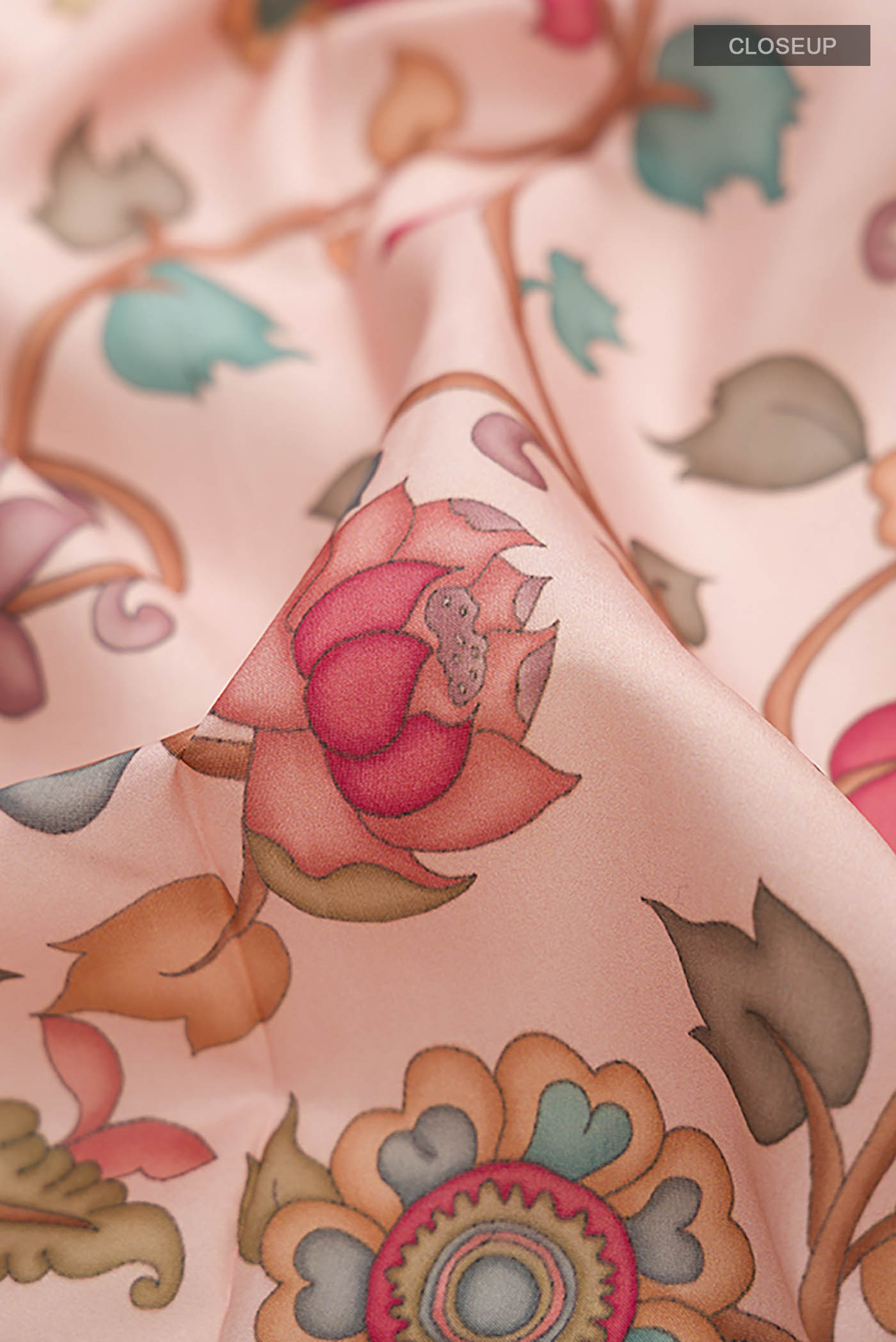 Close up of Rose pink Printed Silk Saree with Printed design on the body and Thread Border displaying folds