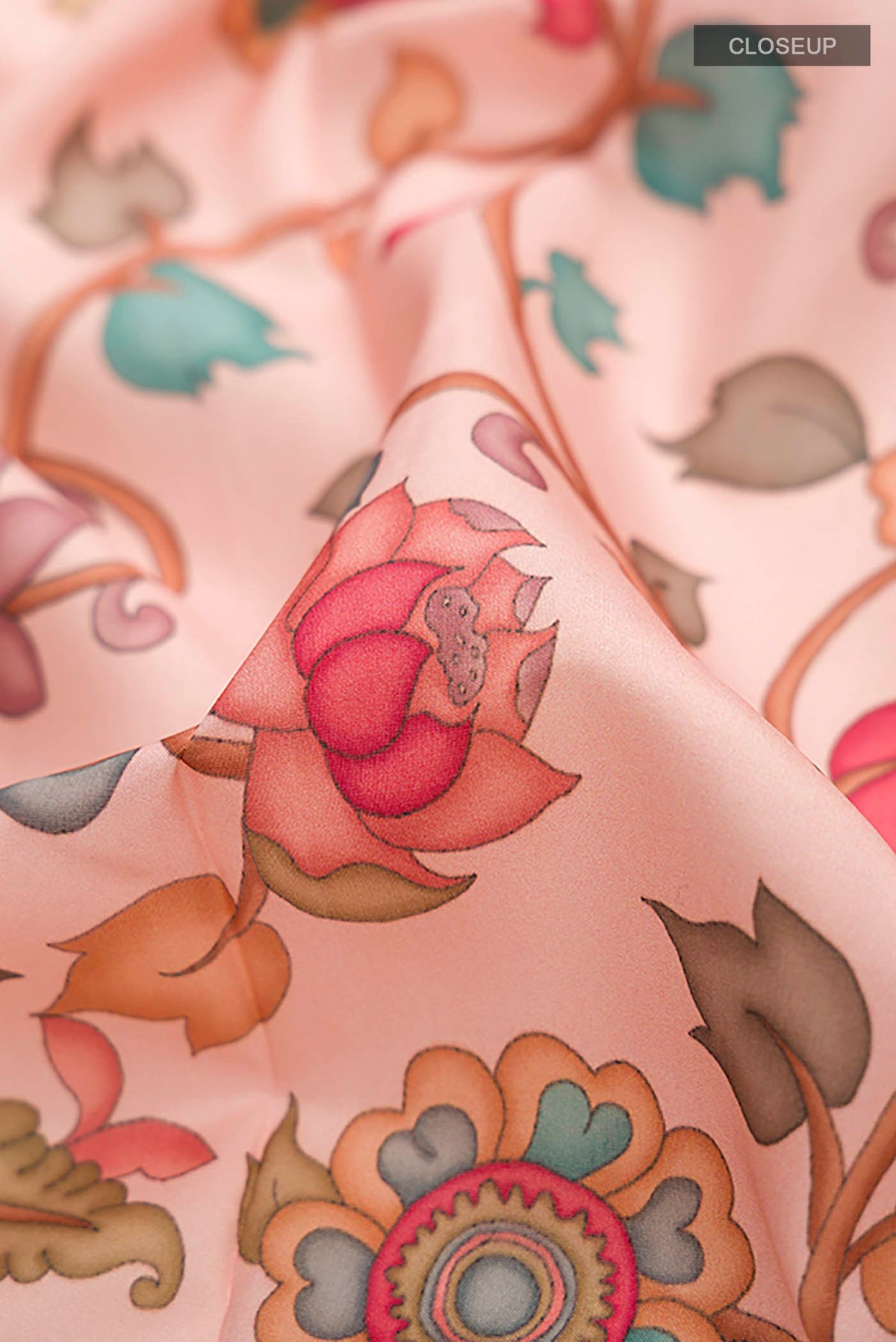 Close up of Rose pink Printed Silk Saree with Printed design on the body and Thread Border displaying folds