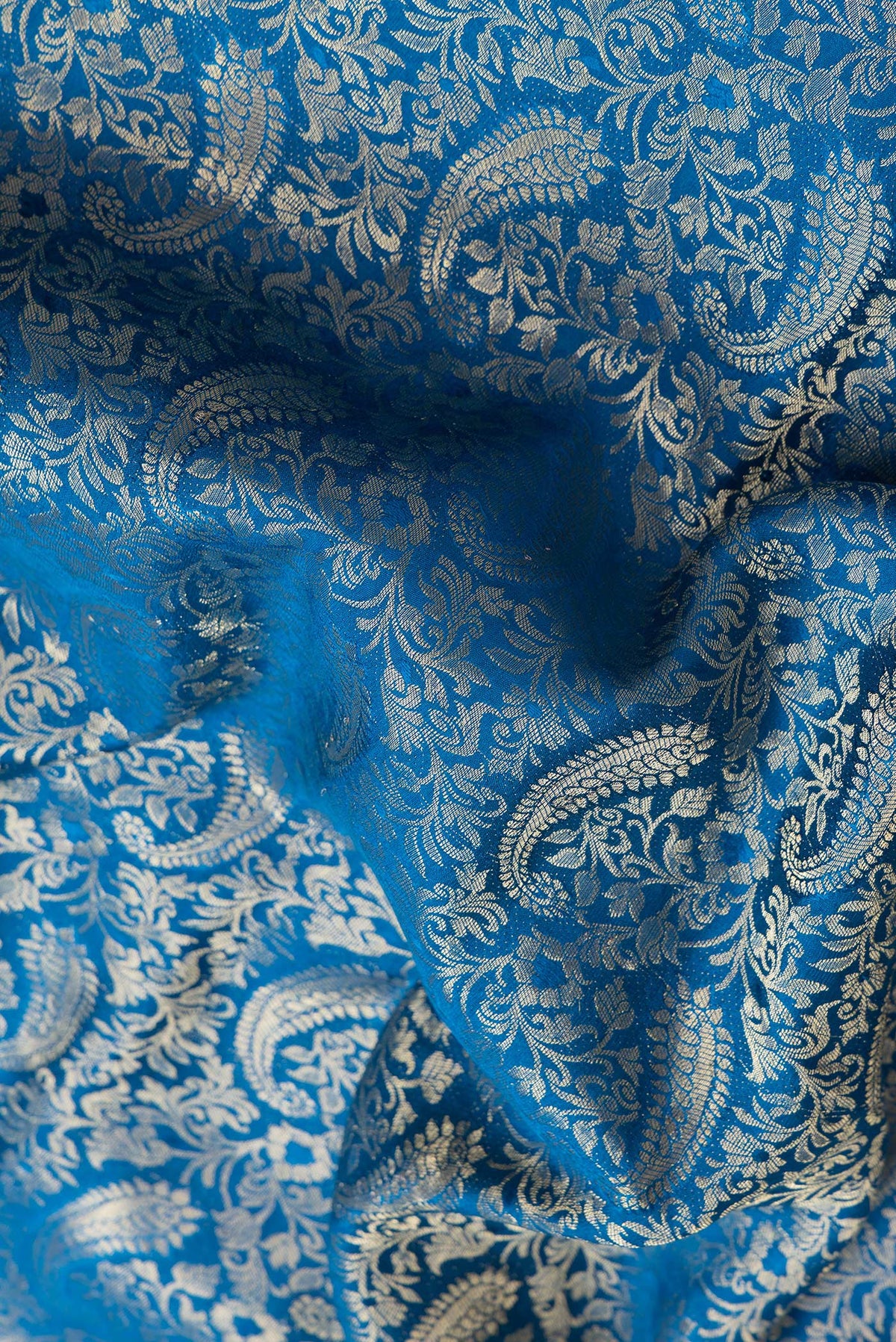 Close up of Peacock Blue Dual Tone Mysore Silk Saree with Zari Brocade on the body and Zari Border.  displaying folds