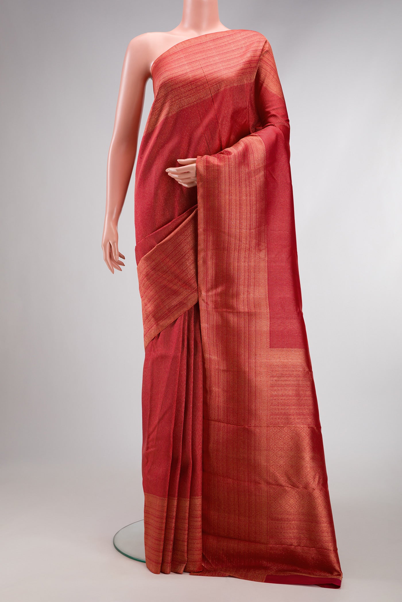 Red Dual Tone Kanjivaram Silk Saree with Zari Brocade on the body and Zari Border.  displayed on a mannequin