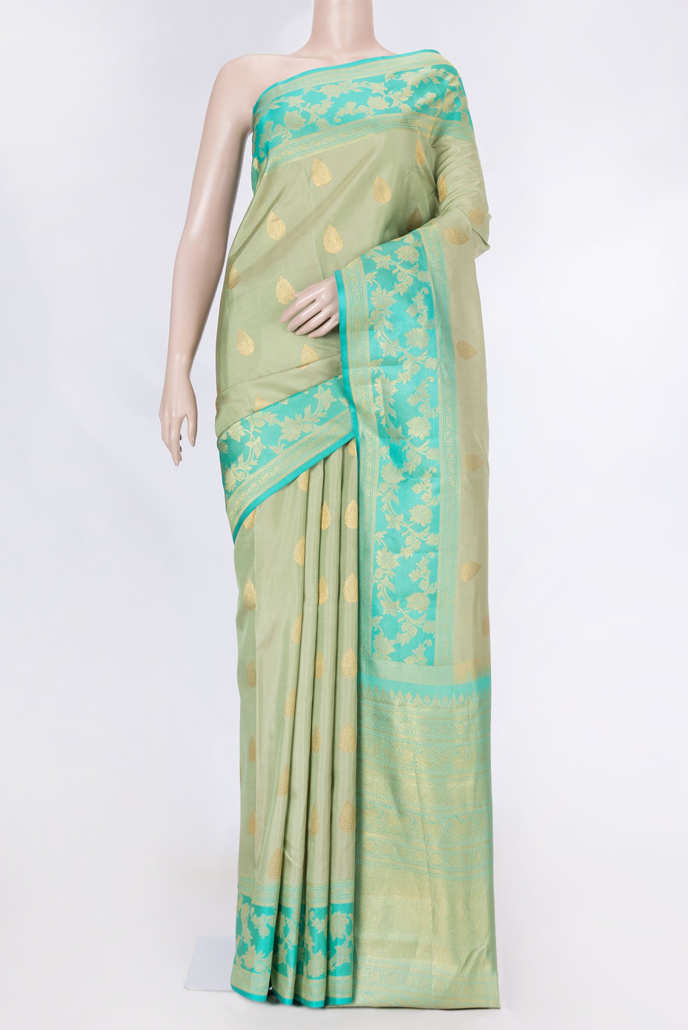 Pista Green Dual Tone Kanchipuram Saree with Zari Butta on the body and Zari Border displayed on a mannequin