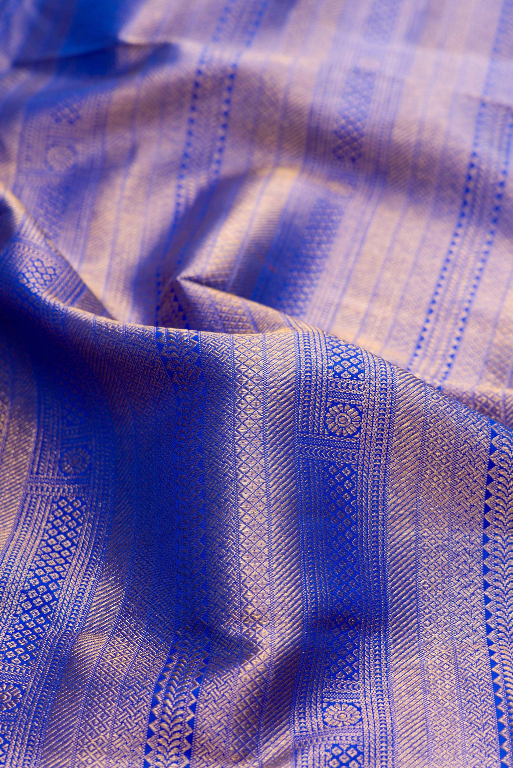 Close up of Royal Blue Dual Tone Kanjivaram Silk Saree with Zari Brocade on the body and Zari Border.  displaying folds