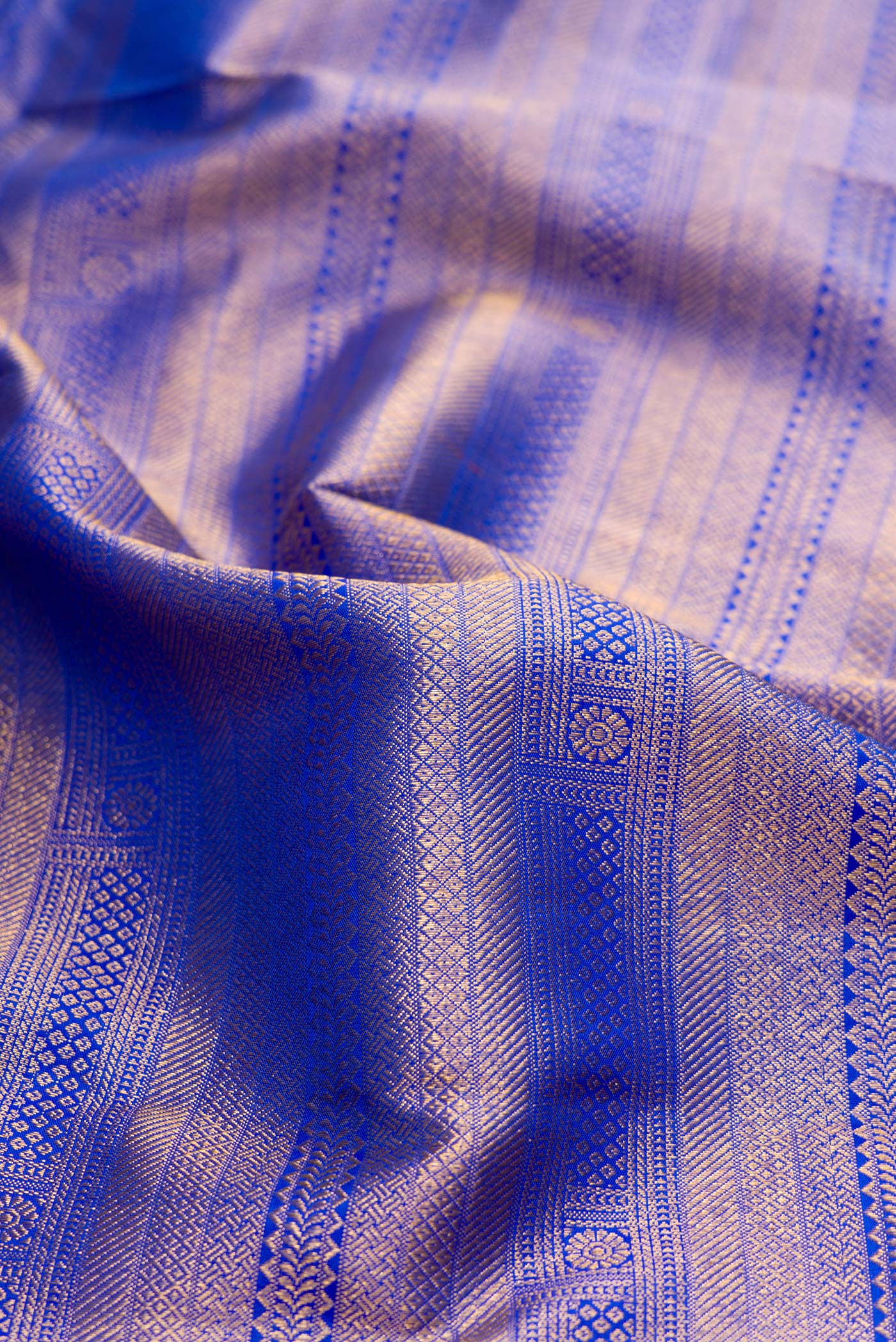 Close up of Royal Blue Dual Tone Kanjivaram Silk Saree with Zari Brocade on the body and Zari Border.  displaying folds