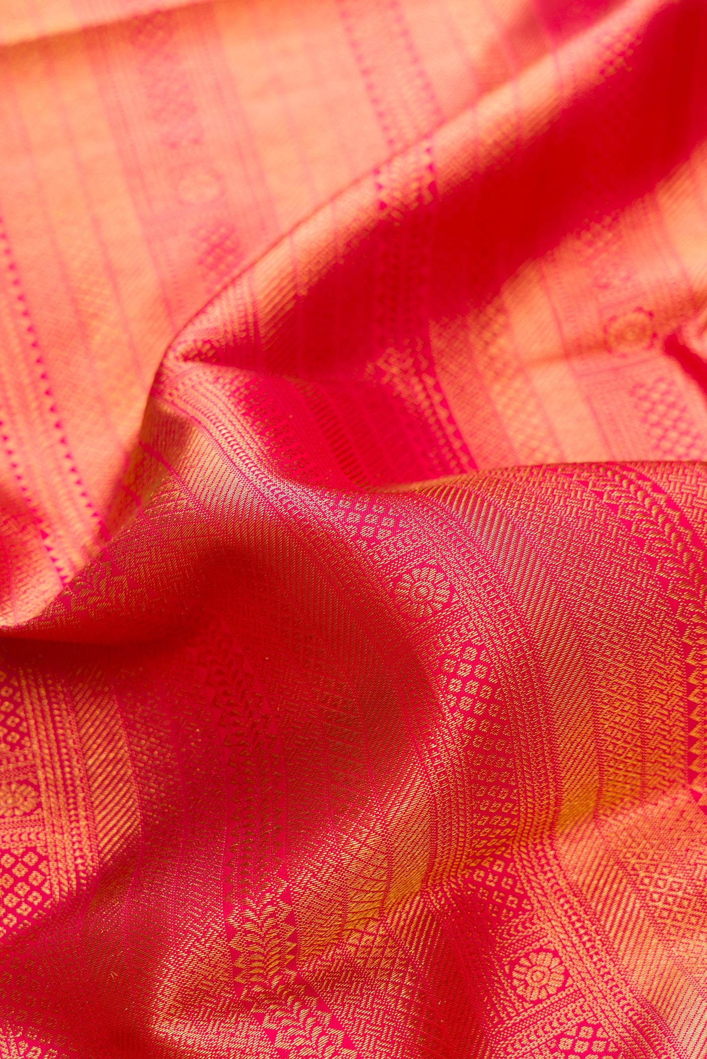 Close up of Pink Dual Tone Kanjivaram Silk Saree with Zari Brocade on the body and Fancy Border.  displaying folds