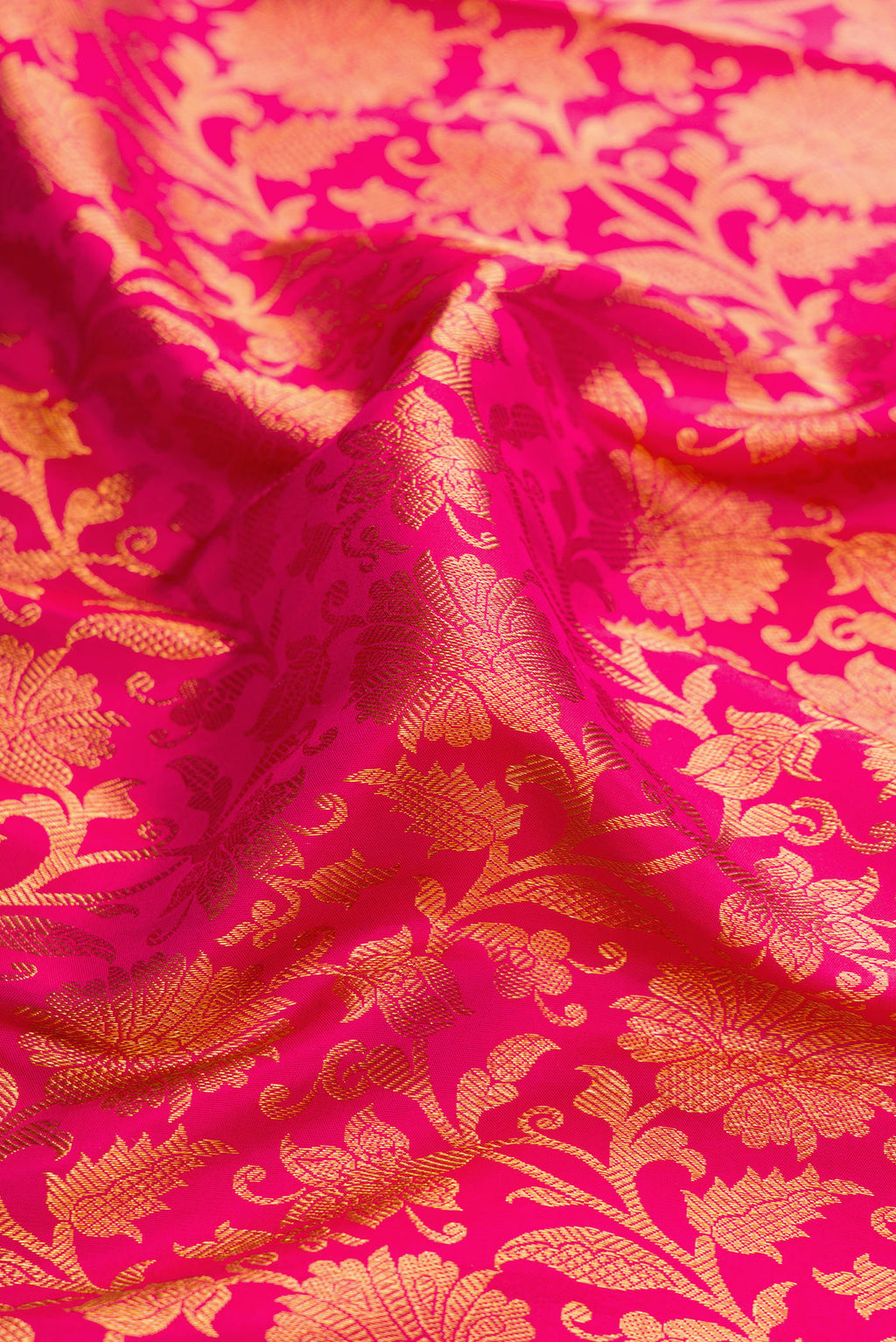 Close up of Dark Pink Dual Tone Kanjivaram Silk Saree with Zari Brocade on the body and Zari Border.  displaying folds