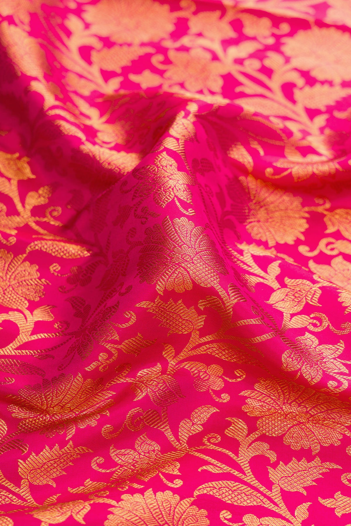 Close up of Dark Pink Dual Tone Kanjivaram Silk Saree with Zari Brocade on the body and Zari Border.  displaying folds