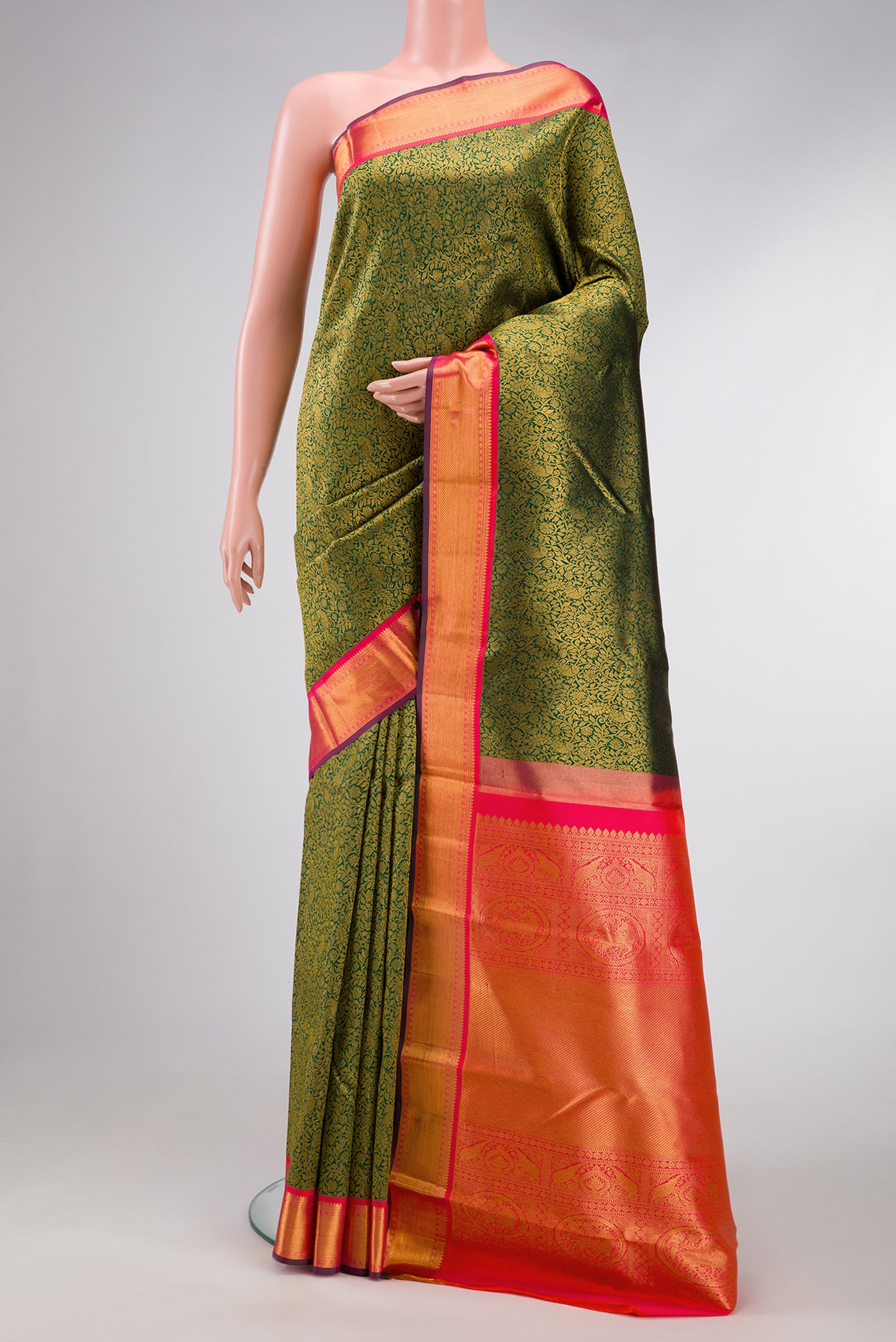 Bottle Green Dual Tone Kanjivaram Silk Saree with Zari Brocade on the body and Zari Border.  displayed on a mannequin