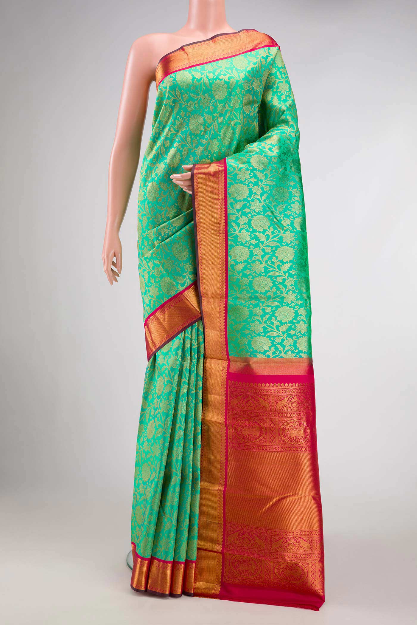 Sea Green Dual Tone Kanjivaram Silk Saree with Zari Brocade on the body and Zari Border.  displayed on a mannequin