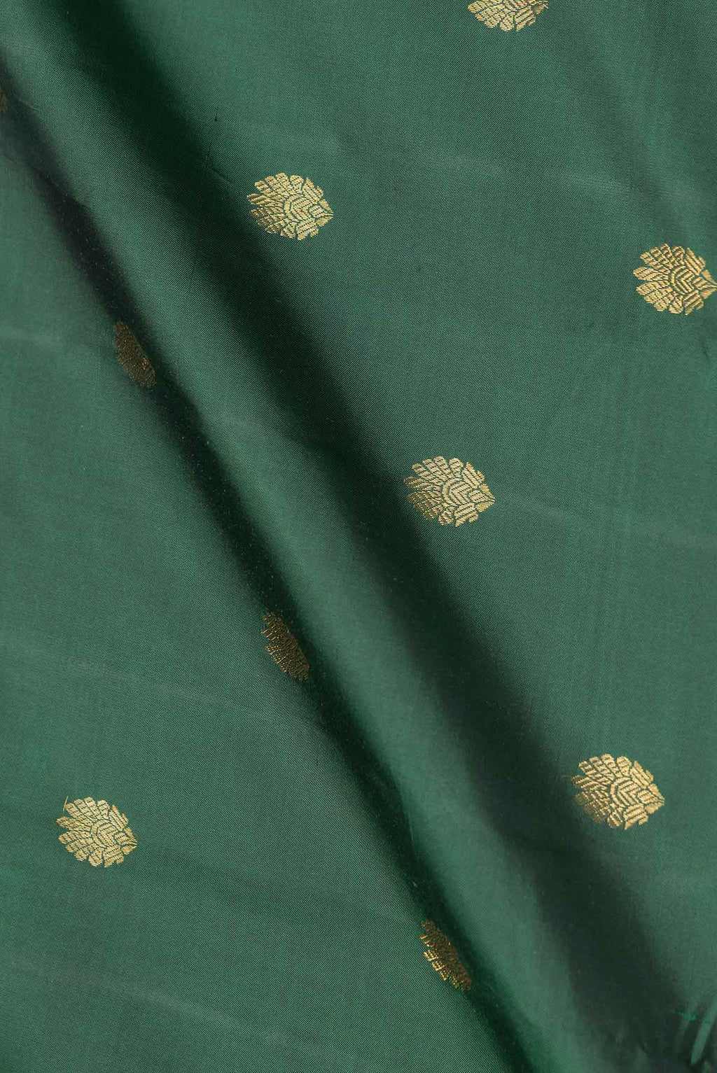 Close up of Green Dual Tone Kanchipuram Saree with Zari Butta on the body and Zari Border.  displaying folds