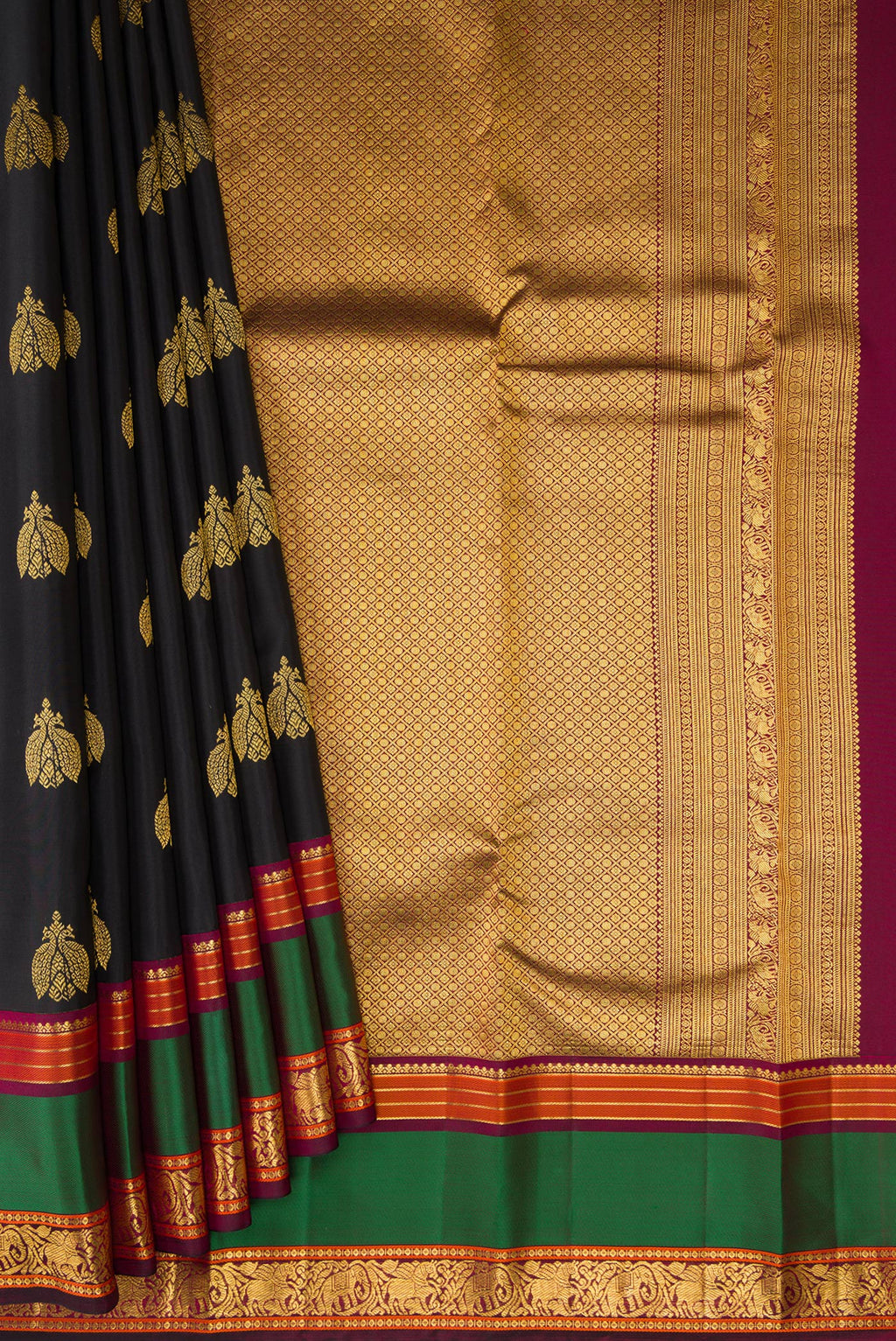 Pleats and pallu of Black Kanjivaram Silk Saree with Zari Butta on the body and Zari And Thread Border. 