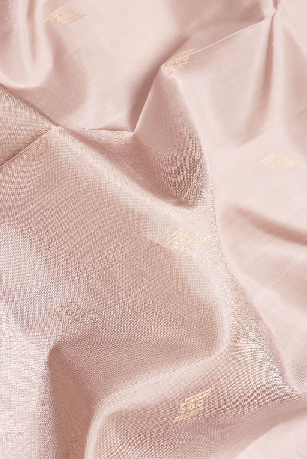 Close up of Beige Dual Tone Soft Silk Saree with Zari Butta on the body and Zari Border.  displaying folds