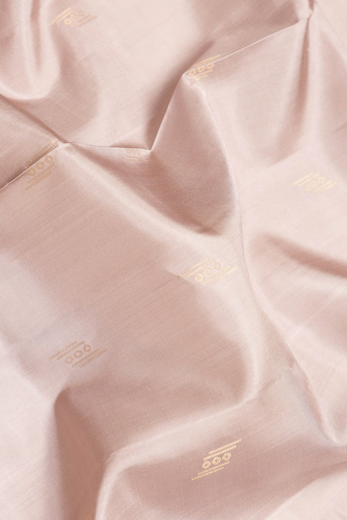 Close up of Beige Dual Tone Soft Silk Saree with Zari Butta on the body and Zari Border.  displaying folds