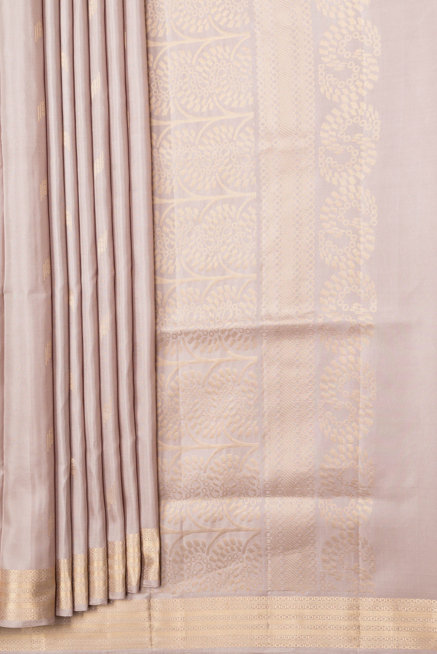 Pleats and pallu of Beige Dual Tone Soft Silk Saree with Zari Butta on the body and Zari Border. 