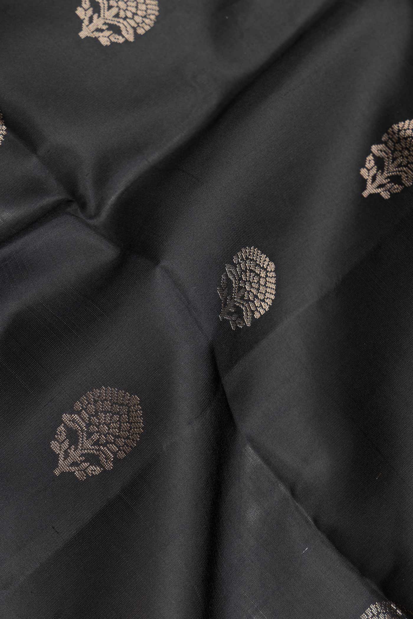 Close up of Black Dual Tone Soft Silk Saree with Zari Butta on the body and Zari Border.  displaying folds