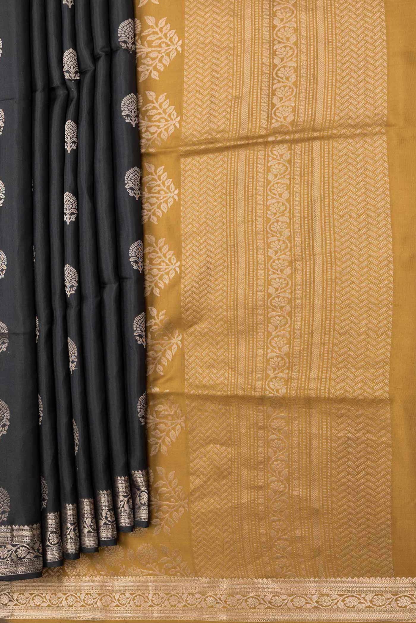 Pleats and pallu of Black Dual Tone Soft Silk Saree with Zari Butta on the body and Zari Border. 