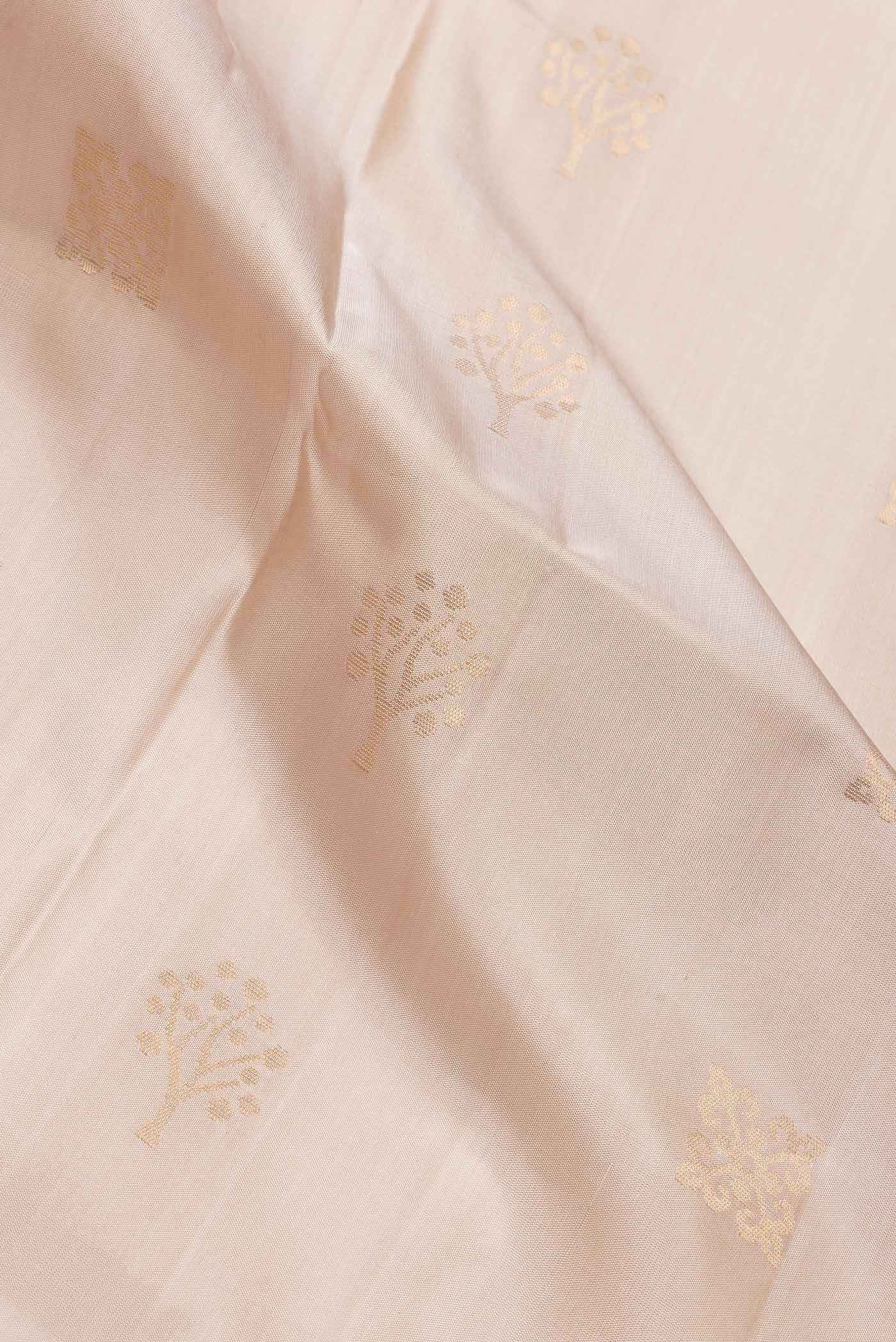 Close up of Beige Dual Tone Soft Silk Saree with Zari Butta on the body and Zari Border.  displaying folds