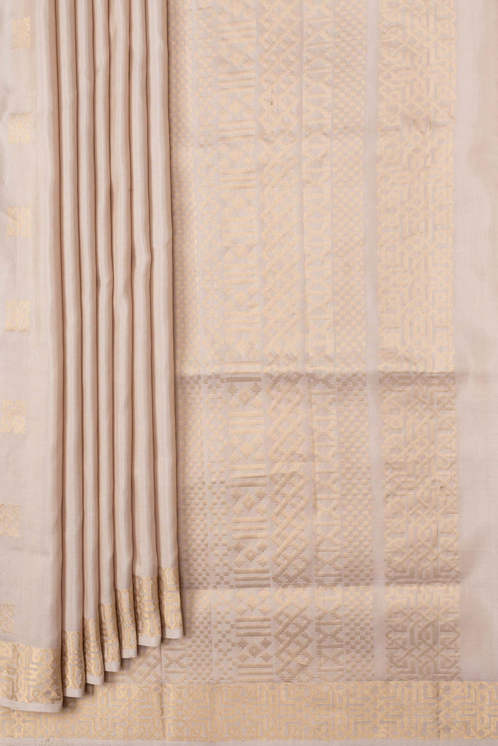 Pleats and pallu of Beige Dual Tone Soft Silk Saree with Zari Butta on the body and Zari Border. 