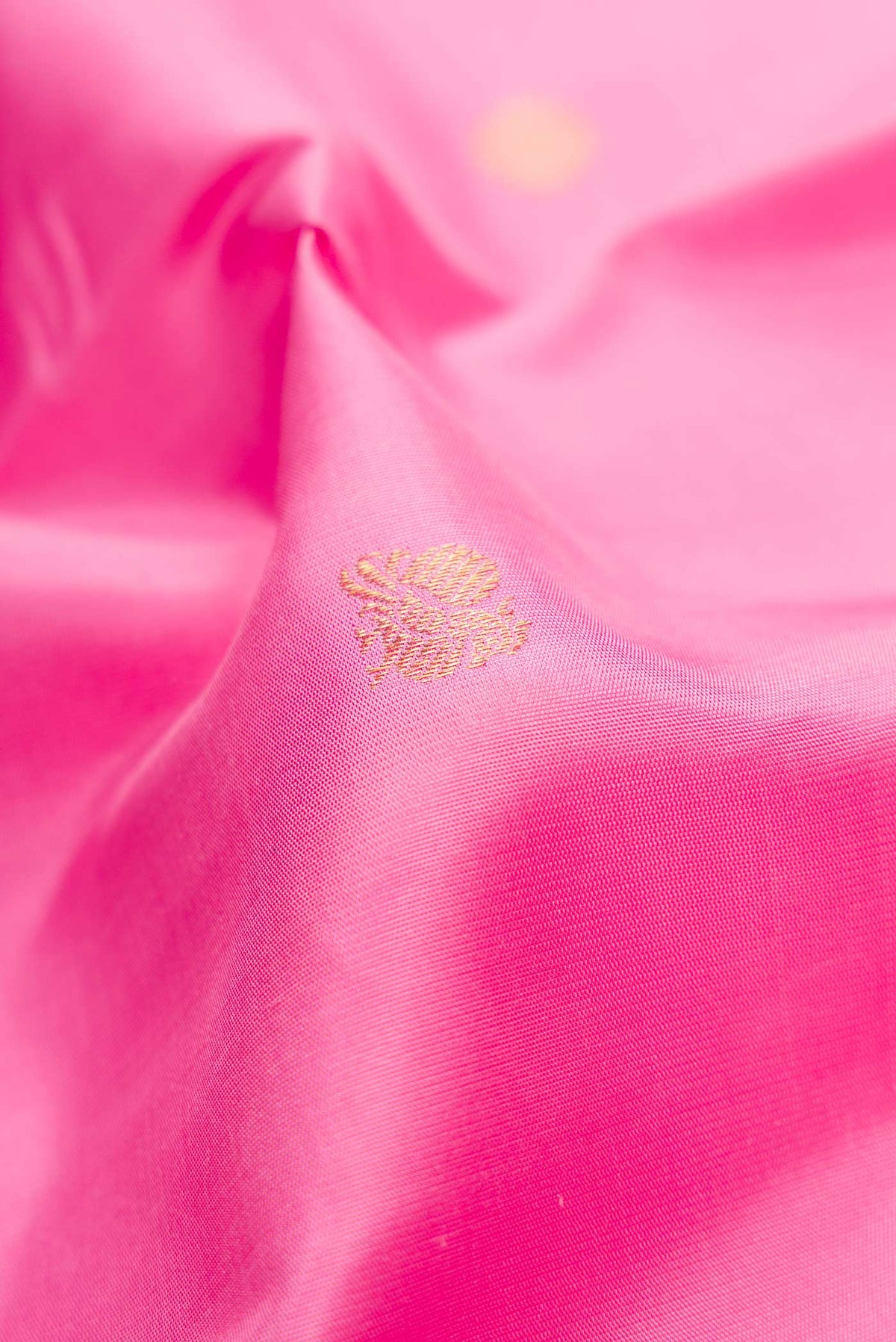 Close up of Pink Dual Tone Kanjivaram Silk Saree with Zari Butta on the body and Zari Border.  displaying folds