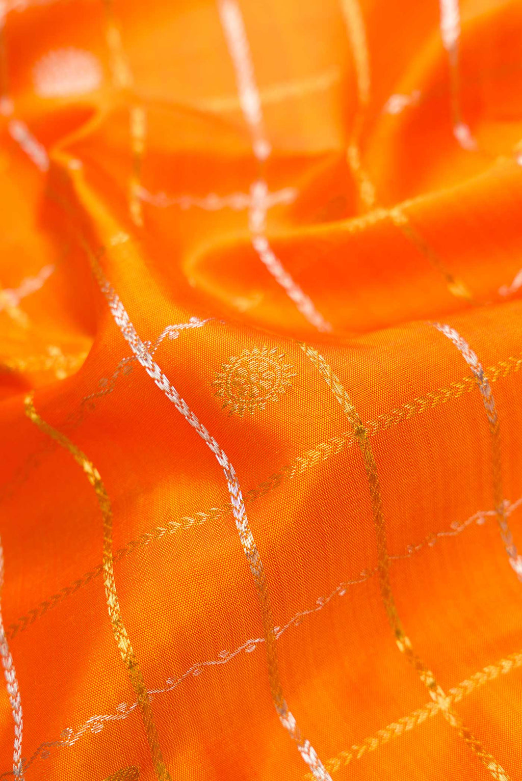 Close up of Orange Dual Tone Kanjivaram Silk Saree with Checked design on the body and Zari Border.  displaying folds