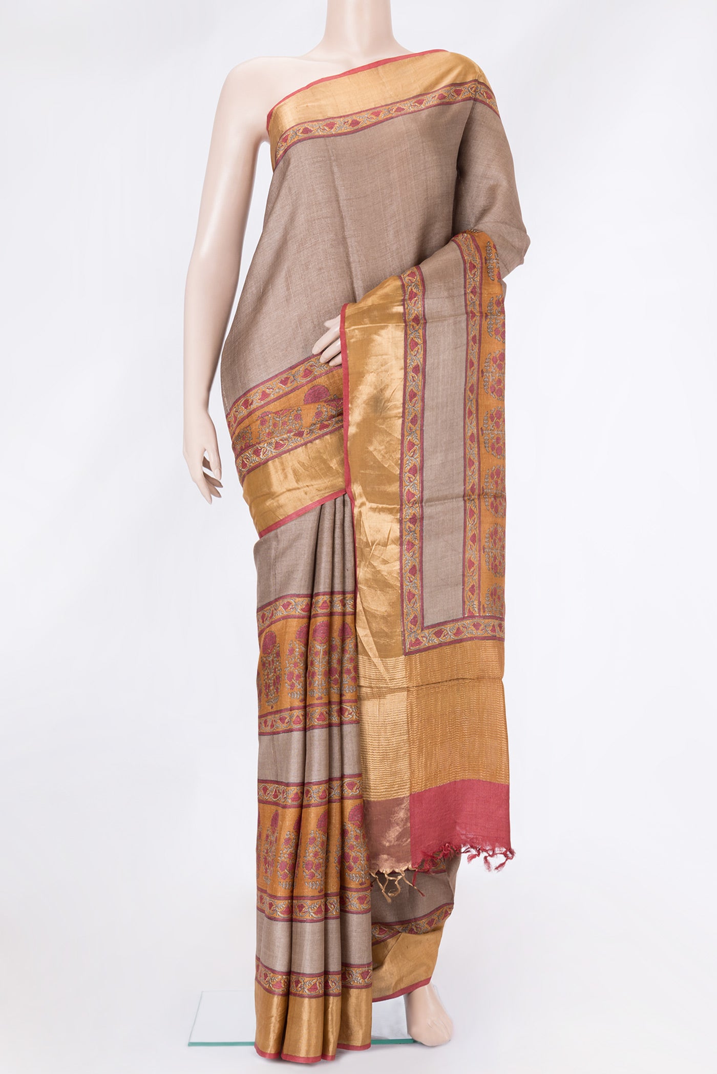 Brown Tussar Silk Saree with Printed design on the body and Zari Border.  displayed on a mannequin