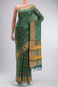 Green Bhagalpuri Tussar Silk Saree with Printed design on the body and Zari Border displayed on a mannequin