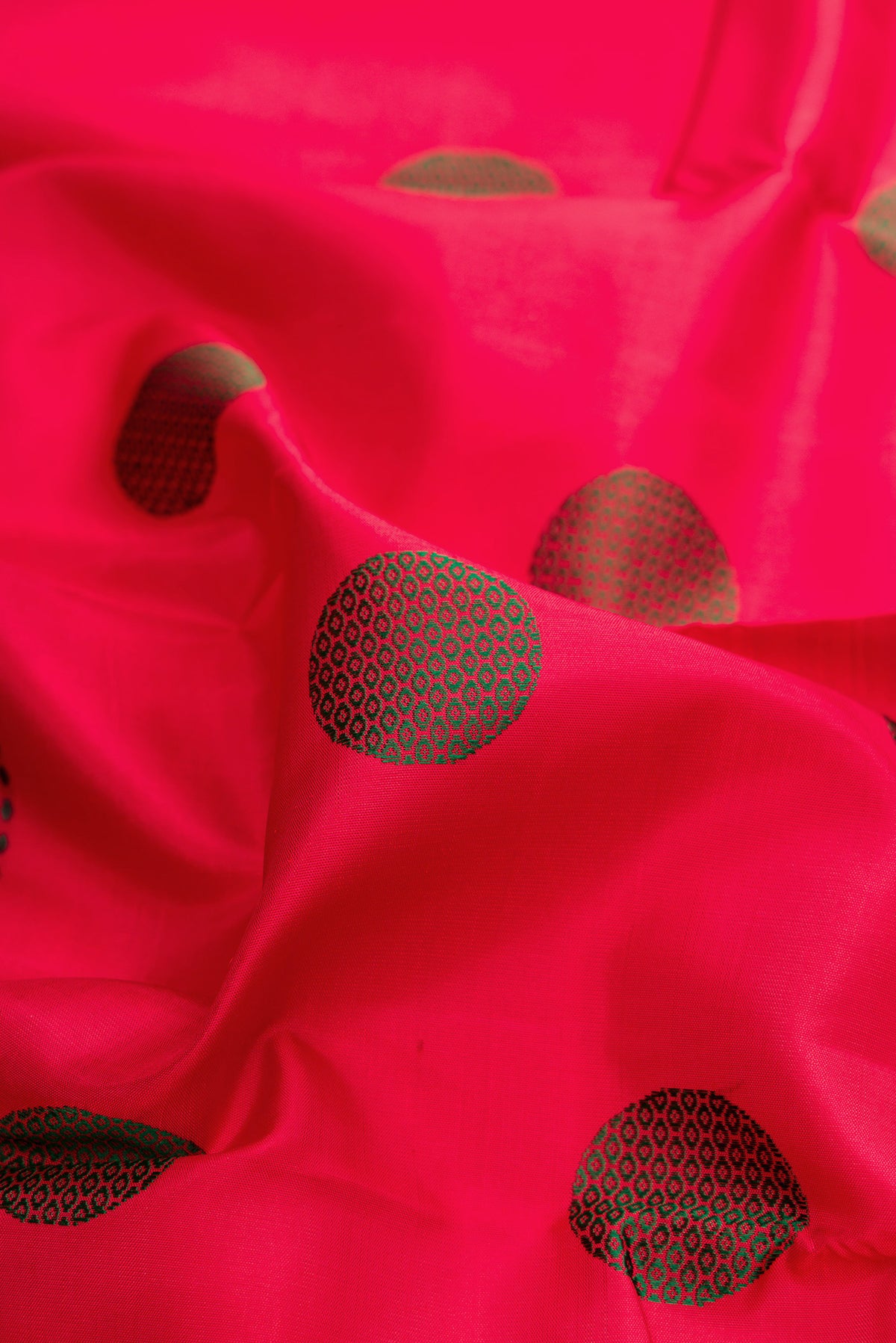 Close up of Pure Silk Red Kanchipuram Saree with Thread Butta on the body and Zari And Thread Border.  displaying folds