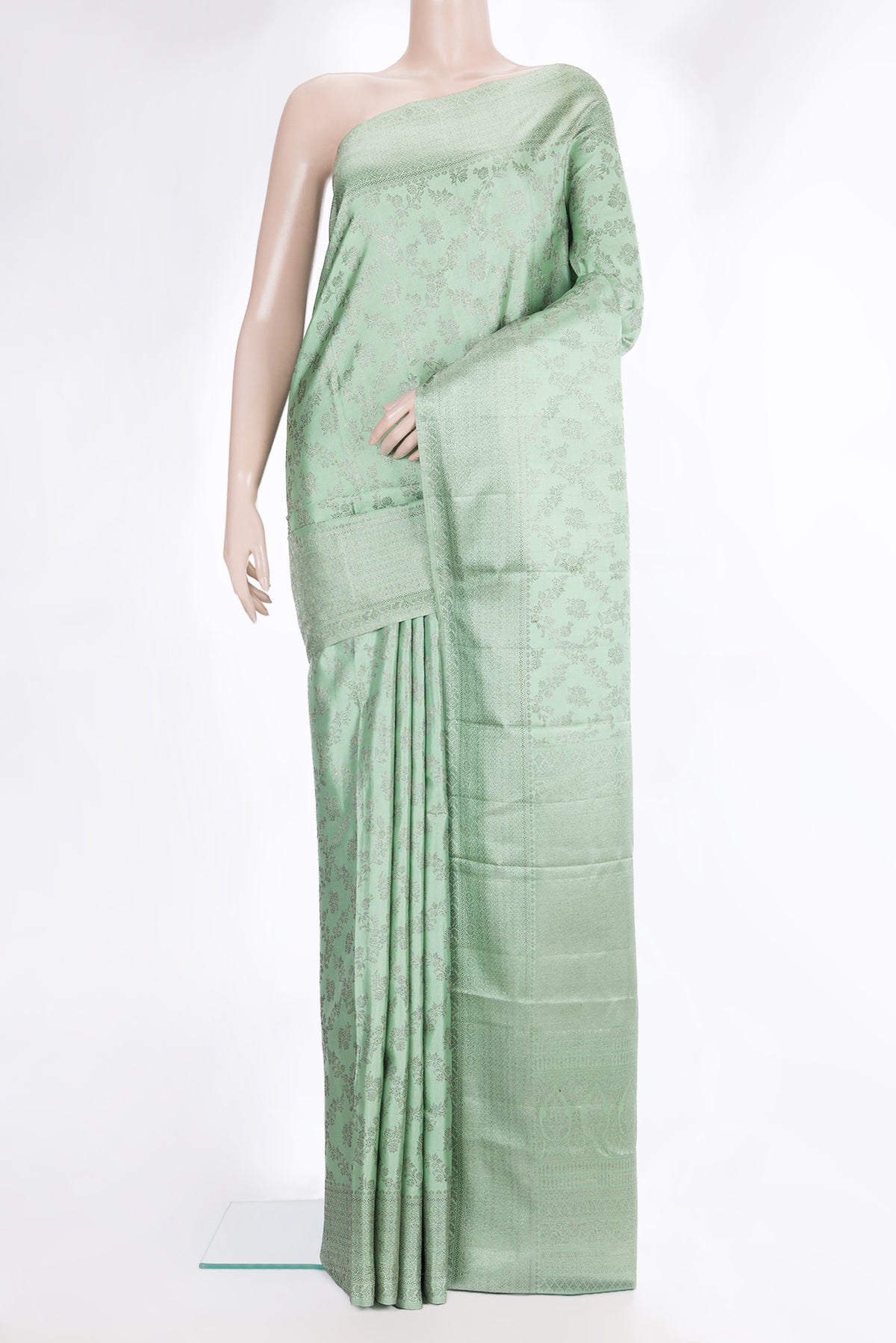 Pure Silk Pista Green Kanjivaram Saree with Zari Brocade on the body and Fancy Border.  displayed on a mannequin
