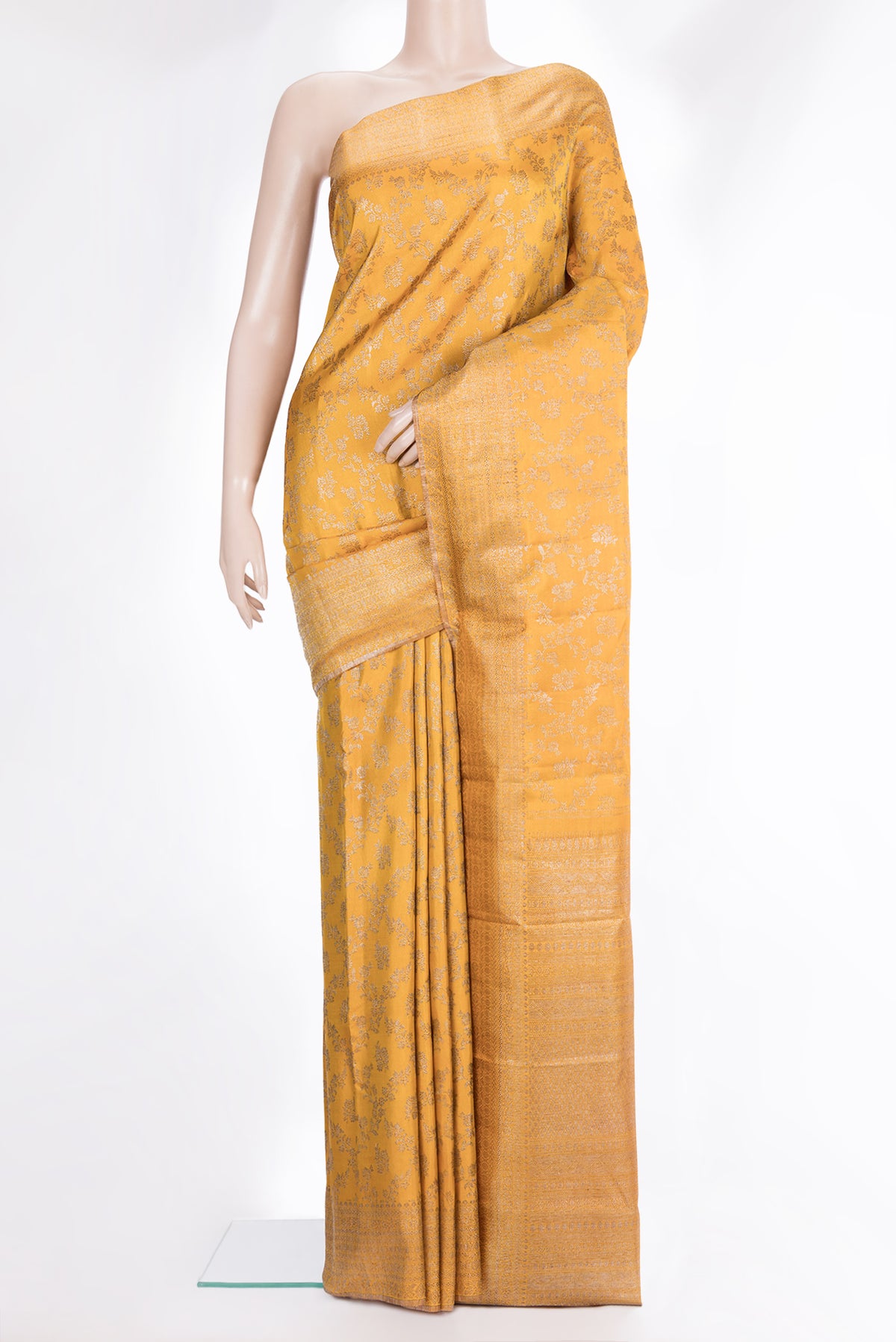 Pure Silk Mustard Kanjivaram Saree with Zari Brocade on the body and Fancy Border.  displayed on a mannequin