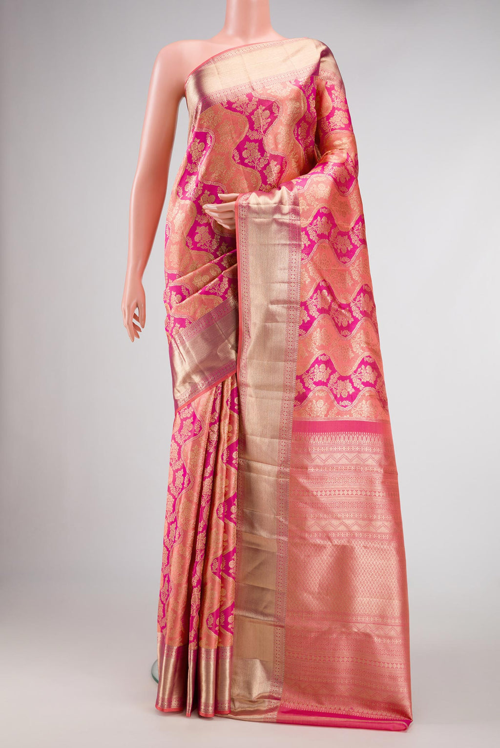 Golden Peach and Pink Color Kanjivaram Silk Saree with Zari Brocade on the body and Zari Border.  displayed on a mannequin