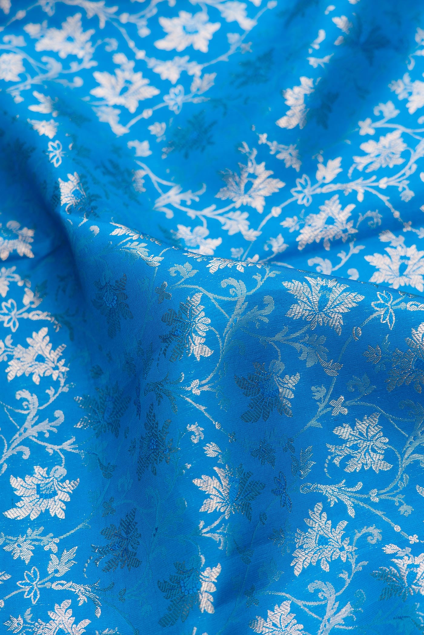 Close up of Sky Blue Dual Tone Kanchipuram Silk Saree with Zari Brocade on the body and Zari Border.  displaying folds