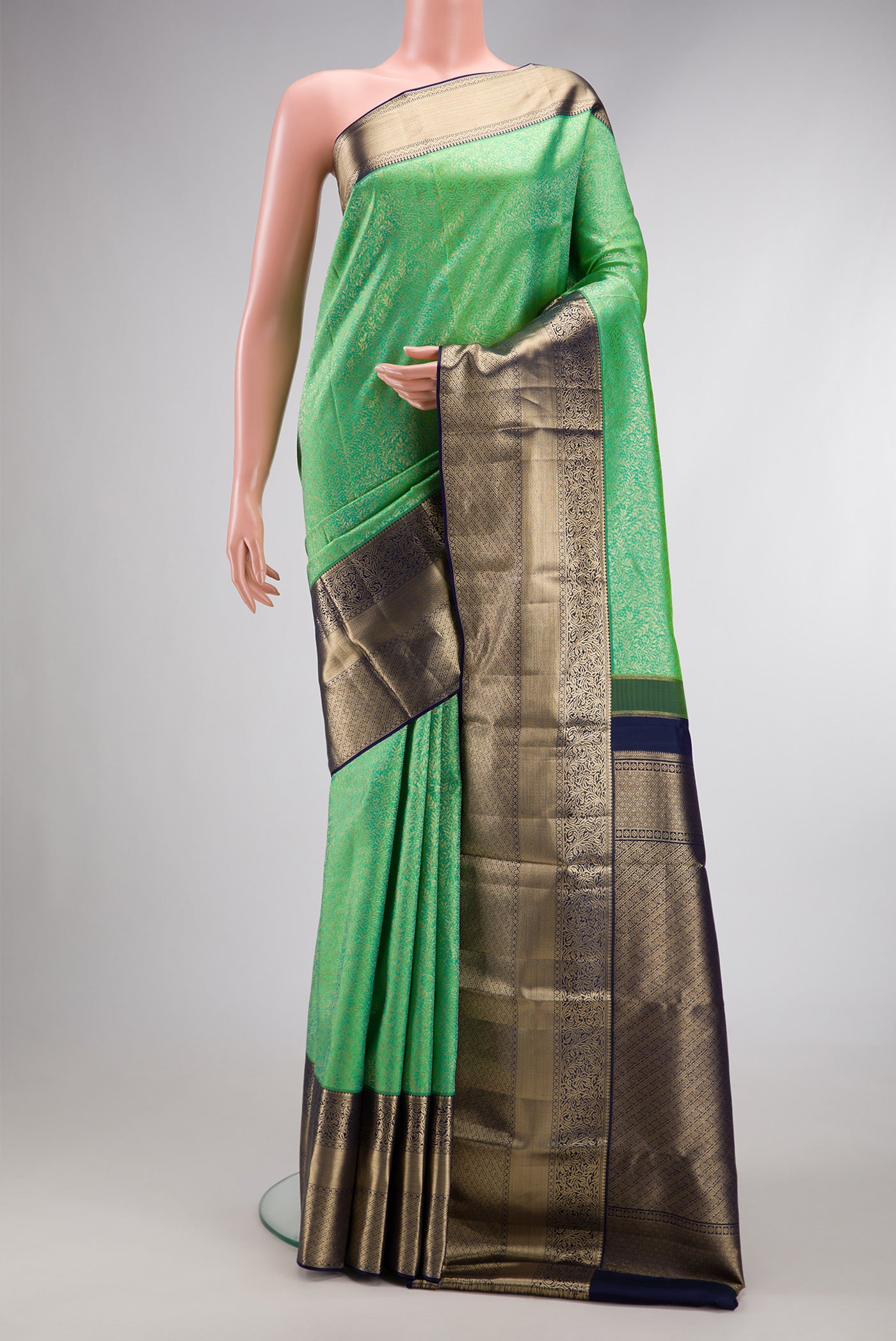 Sea Green Dual Tone Kanchipuram Silk Saree with Zari Brocade on the body and Zari Border.  displayed on a mannequin