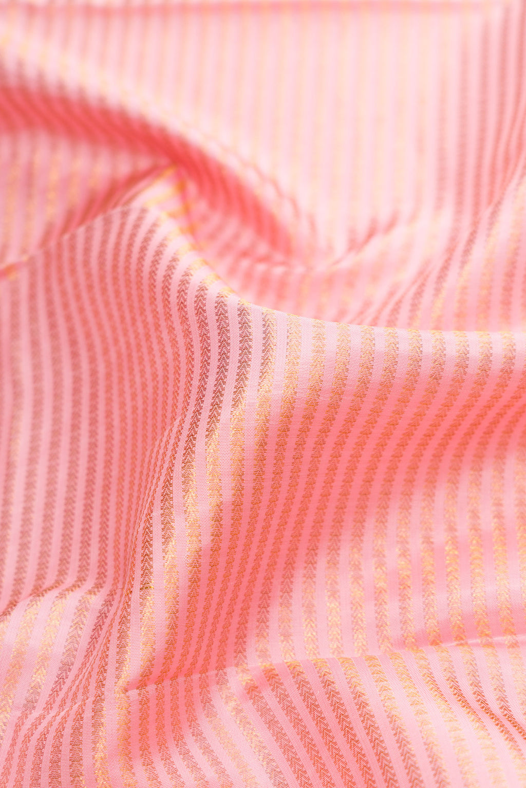 Close up of Pink Dual Tone Kanchipuram Silk Saree with Zari Brocade on the body and Zari Border.  displaying folds