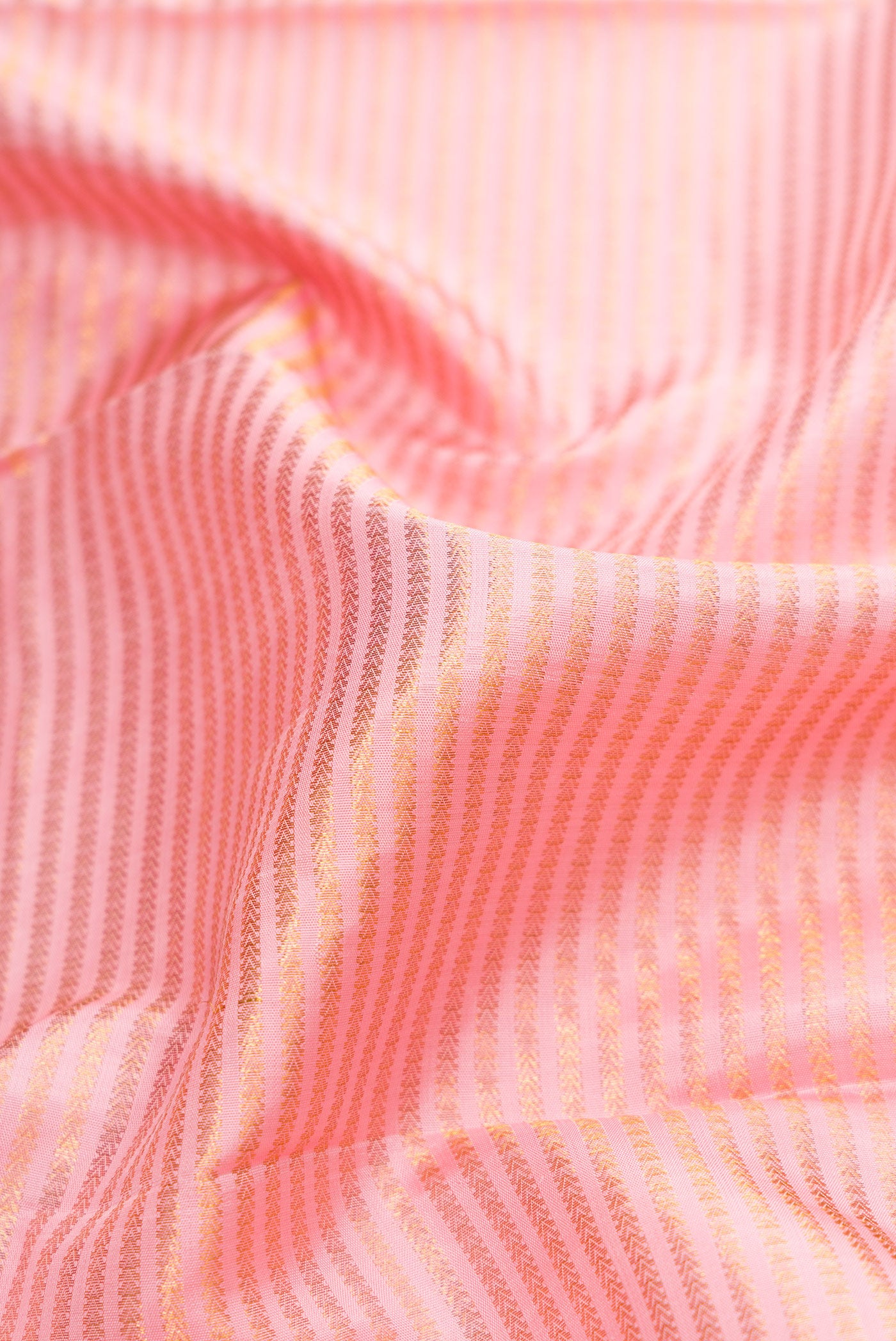 Close up of Pink Dual Tone Kanchipuram Silk Saree with Zari Brocade on the body and Zari Border.  displaying folds