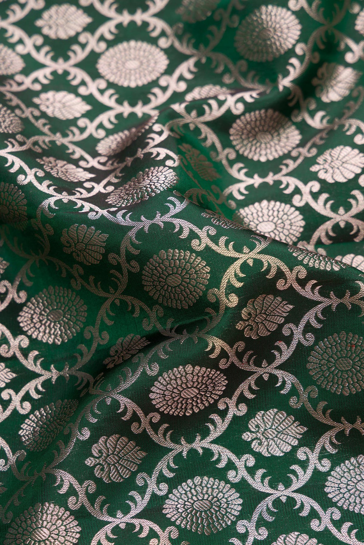Close up of Bottle Green Dual Tone Kanjivaram Silk Saree with Zari Brocade on the body and Zari Border.  displaying folds