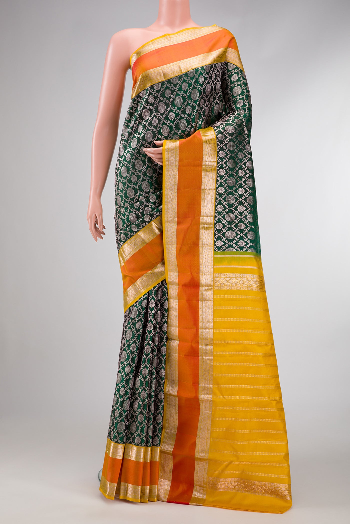 Bottle Green Dual Tone Kanjivaram Silk Saree with Zari Brocade on the body and Zari Border.  displayed on a mannequin