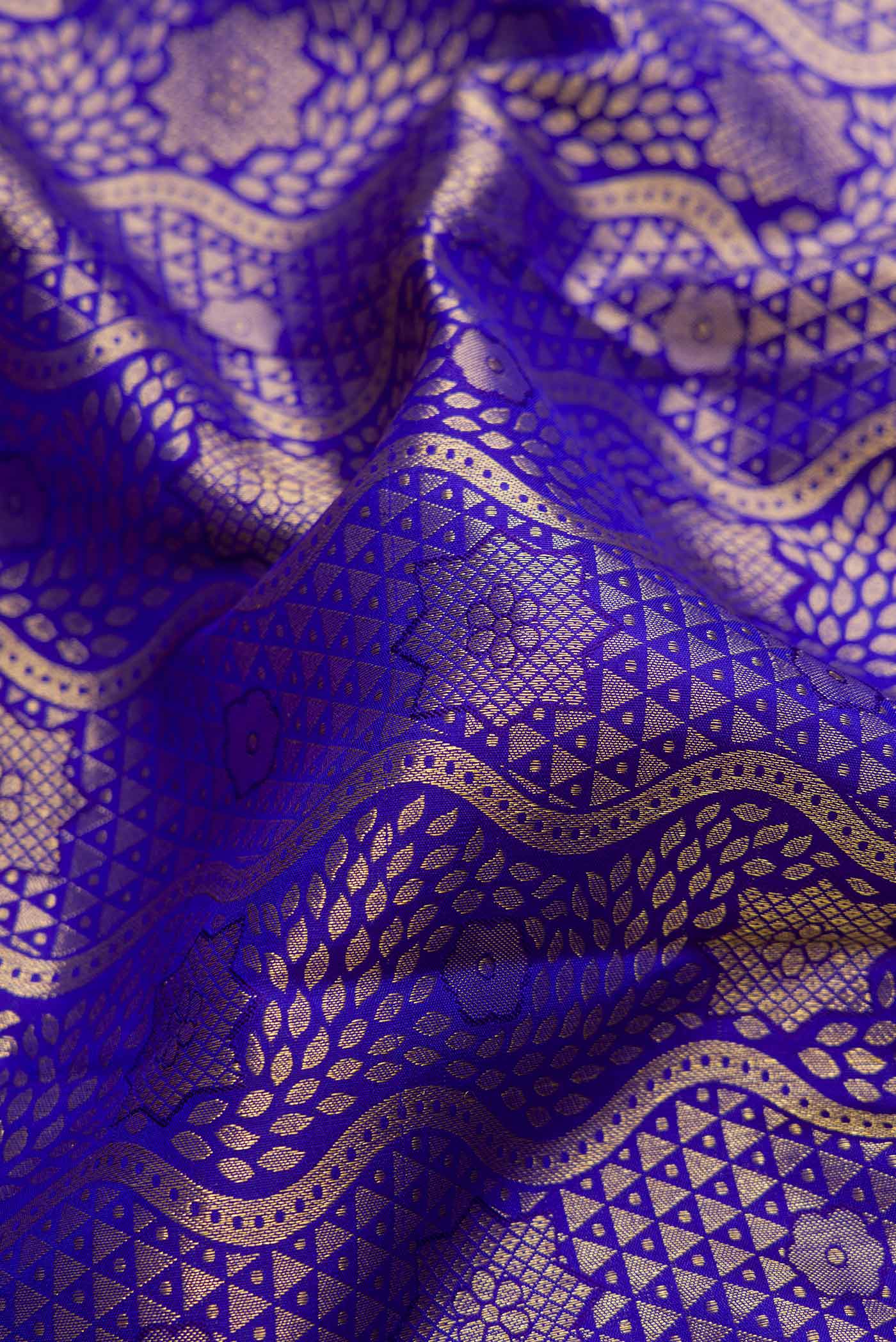 Close up of Royal Blue Dual Tone Kanjivaram Silk Saree with Zari Brocade on the body and Zari Border.  displaying folds