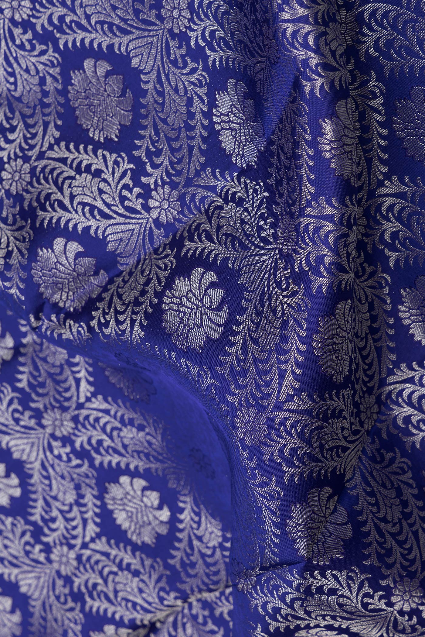 Close up of Royal Blue Dual Tone Kanjivaram Silk Saree with Zari Brocade on the body and Zari Border.  displaying folds