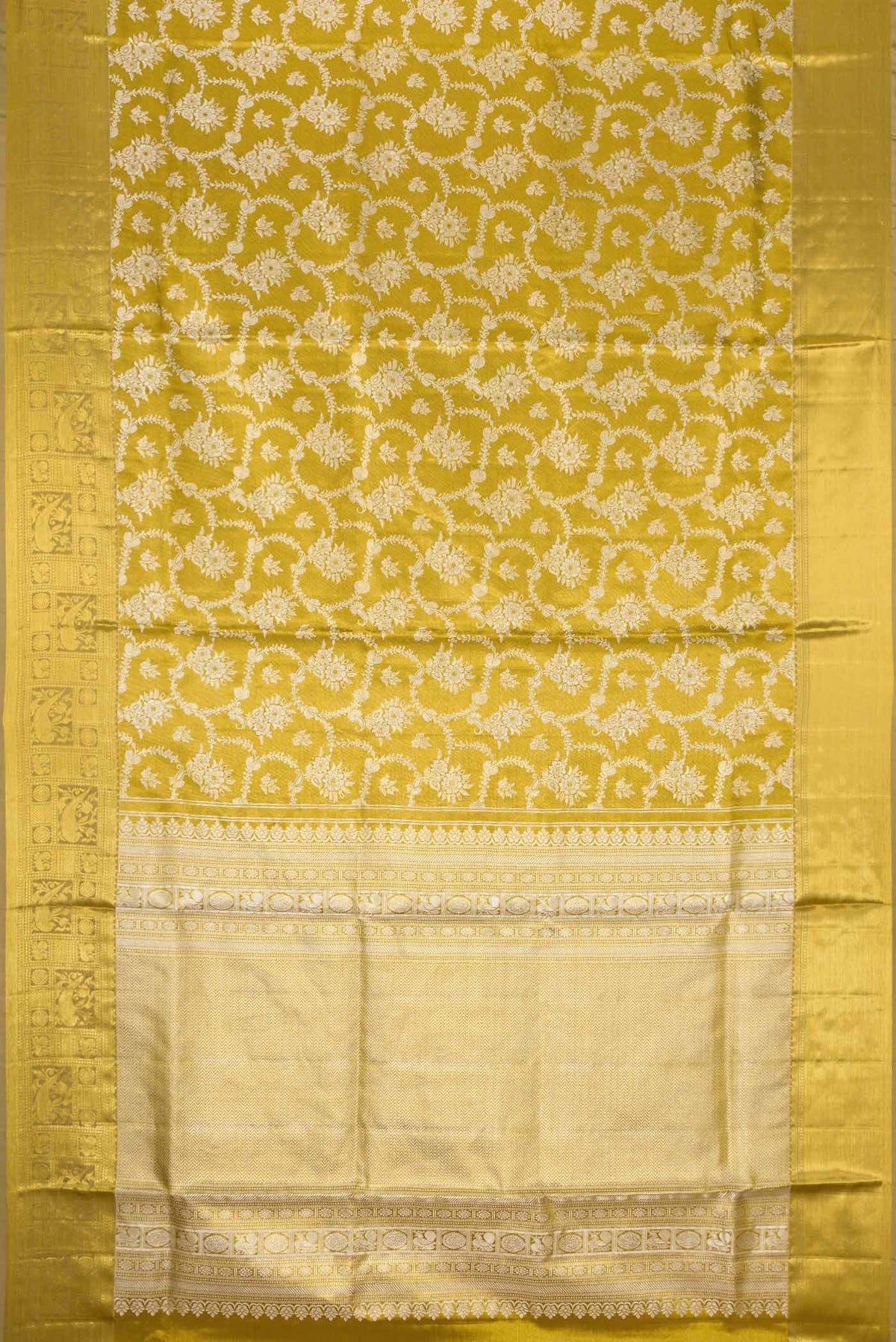 Flat view of Gold Dual Tone Kanjivaram Tissue Silk Saree with Zari Brocade on the body and Zari Border. 