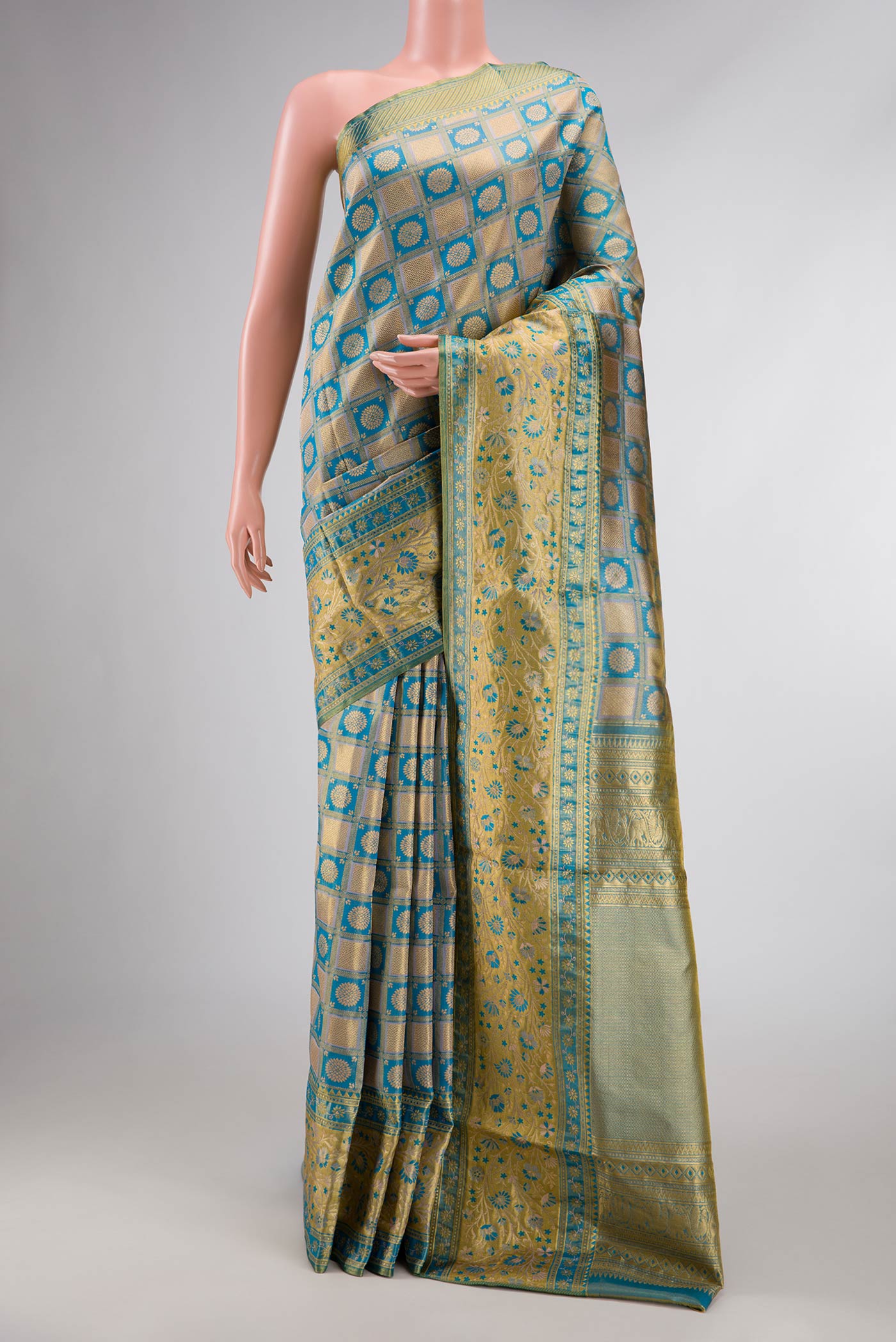 Peacock Blue Dual Tone Kanchipuram Tissue Silk Saree with Zari Brocade on the body and Fancy Border displayed on a mannequin