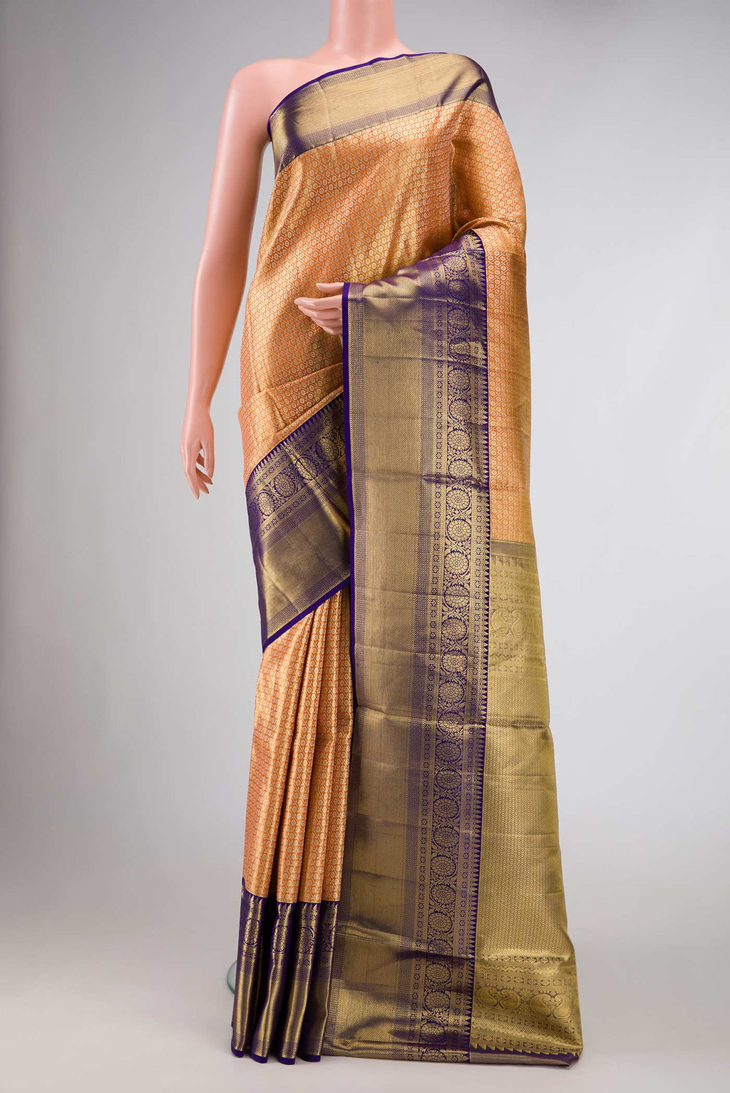Golden Peach Dual Tone Kanchipuram Tissue Silk Saree with Zari Brocade on the body and Zari Border.  displayed on a mannequin