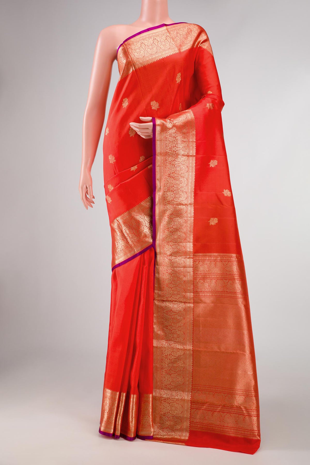 Orange Dual Tone Kanchipuram Silk Saree with Zari Butta on the body and Zari Border displayed on a mannequin