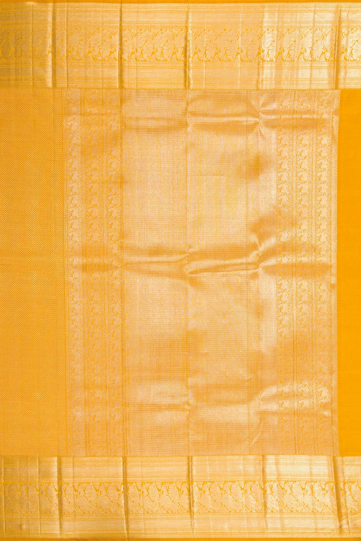 Close up image of the pallu of Mustard Kanchipuram Silk Saree with Zari Brocade on the body and Zari Border. 