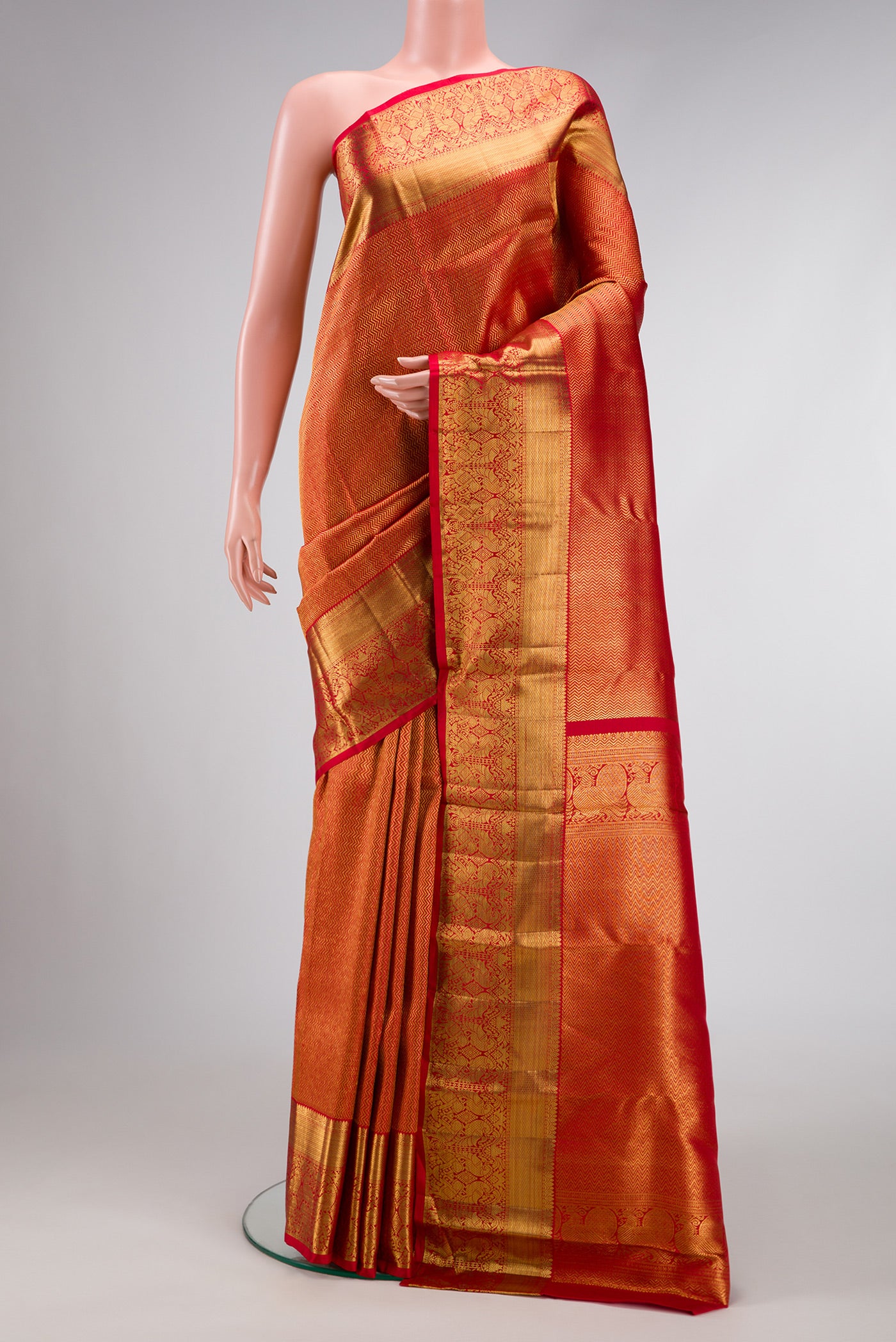Red Dual Tone Kanchipuram Silk Saree with Zari Brocade on the body and Zari Border.  displayed on a mannequin
