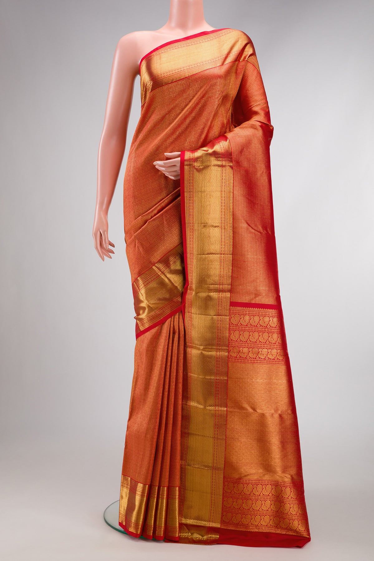Red Kanchipuram Silk Saree with Zari Brocade on the body and Zari Border.  displayed on a mannequin