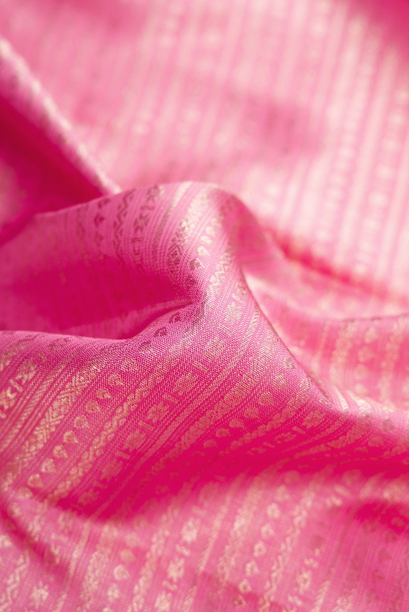 Close up of Pink Dual Tone Kanchipuram Silk Saree with Zari Brocade on the body and Zari Border.  displaying folds