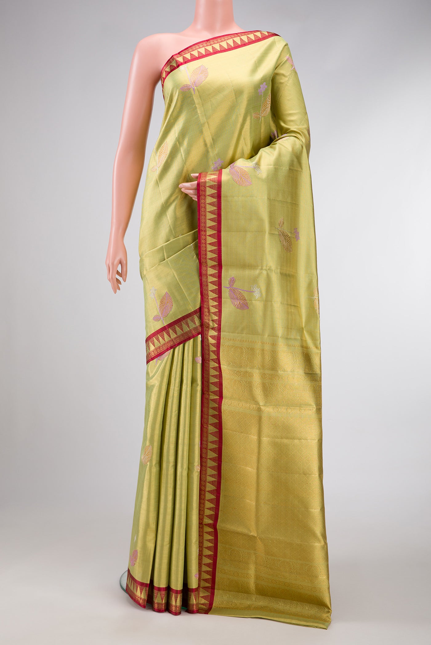Pista Green Dual Tone Kanjivaram Tissue Silk Saree with Zari And Thread Butta on the body and Zari Border.  displayed on a mannequin