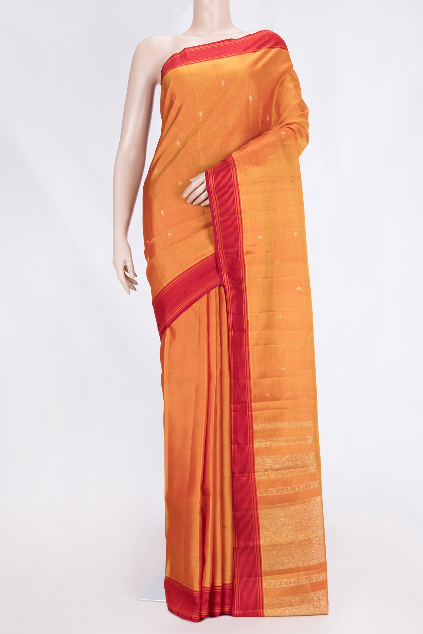 Mustard Dual Tone Kanchipuram Saree with Zari Butta on the body and Thread Border.  displayed on a mannequin