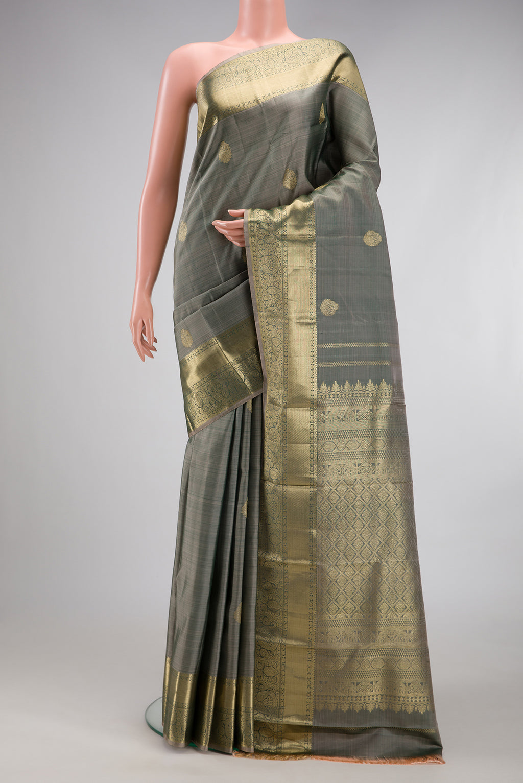 Grey Kanchipuram Silk Saree with Zari Butta on the body and Zari Border.  displayed on a mannequin