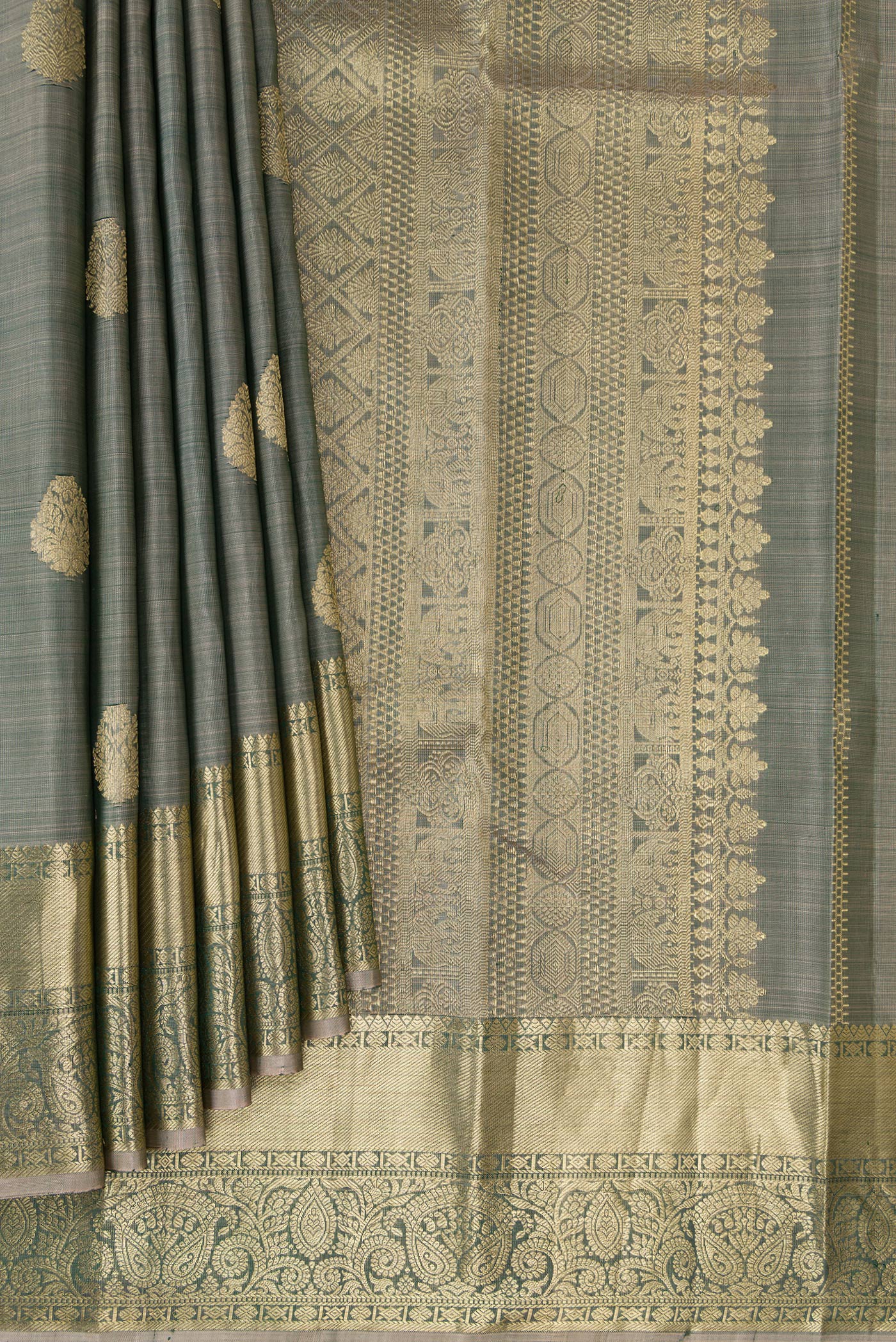 Pleats and pallu of Grey Kanchipuram Silk Saree with Zari Butta on the body and Zari Border. 