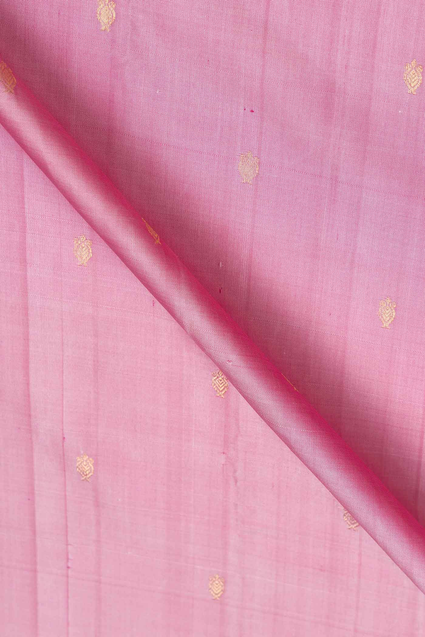 Close up of Pink Dual Tone Kanchipuram Saree with Zari Butta on the body and Thread Border.  displaying folds